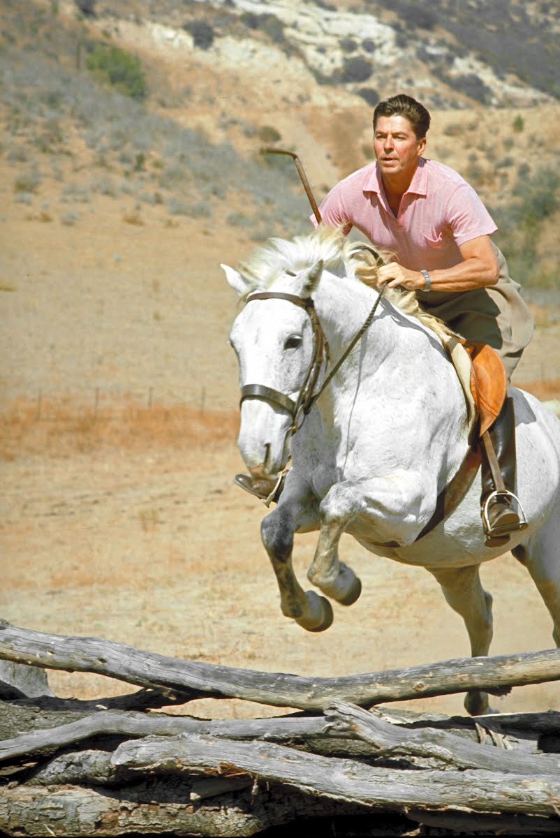 CA gov. candidate Ronald Reagan riding horse at home on ranch. 