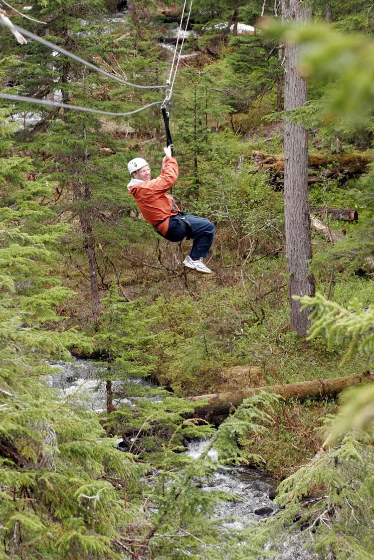 Ziplining over hills and trees near Juneau, Alaska.