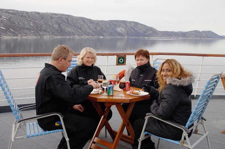 Dine al fresco as never before — surrounded by grand views of Greenland's mountain range and icy waters — aboard a Hurtigruten sailing.