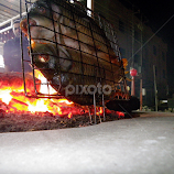 Fish by the fire in Iraq by Benito Flores Jr -  