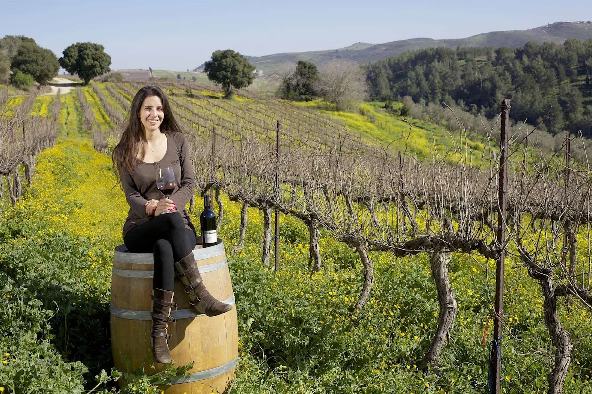 woman-Israel-winery - A woman kicks back amid the vineyards of a winery in Israel.