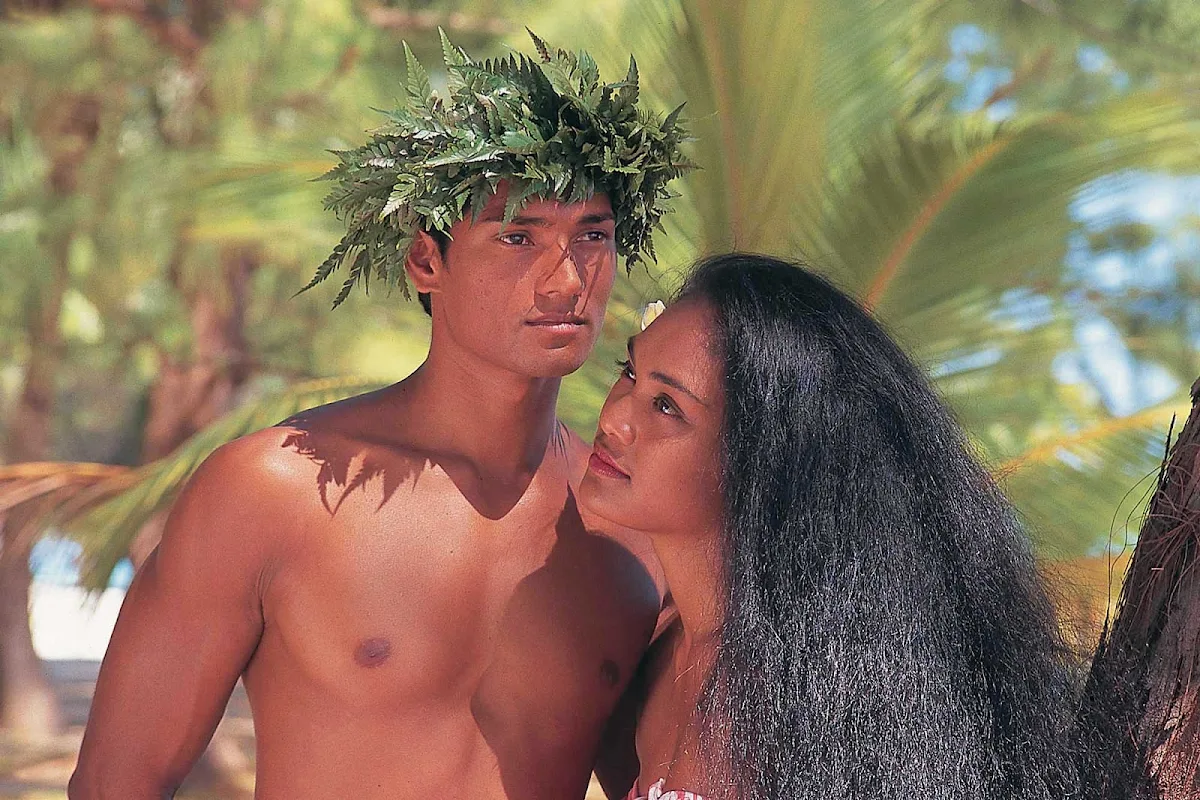 Tahiti-couple - A Tahitian couple in traditional dress are about to greet visitors to their island.