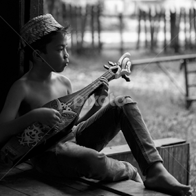Playing Guitar by Richard Liong - Black & White Portraits & People