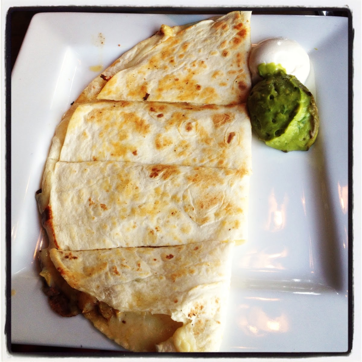 In-edible GF cheese quesadilla with half browned guacamole :(