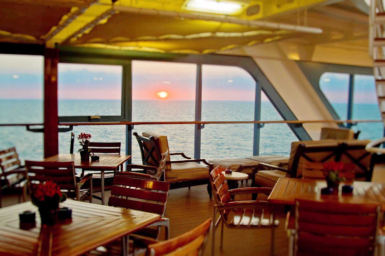 Watch the sun set while enjoying a bite on your Azamara cruise.