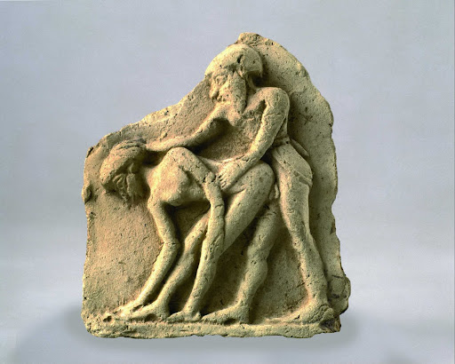 Plaque depicting a couple copulating
