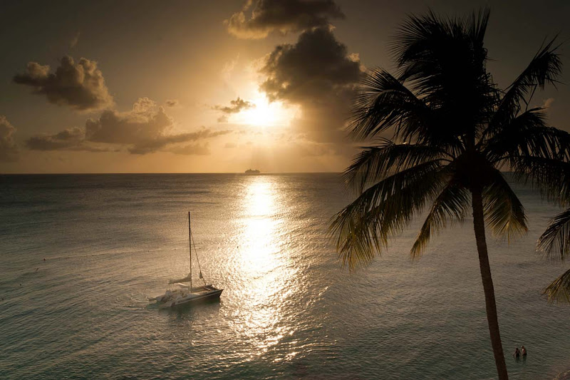 The sun sets on a catamaran on a quiet bay on Barbados.