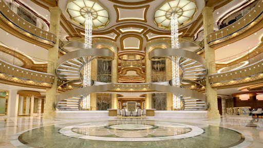 Royal-Princess-atrium-from-Deck5 - Royal Princess’ large piazza-style atrium, seen from deck 5, features spiral staircases, dining options that include Gelato and the Ocean Terrace Seafood Bar, and live entertainment from the nearby bar or lounge.