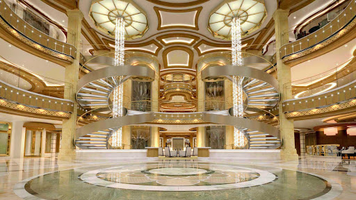 Royal Princess’ large piazza-style atrium, seen from deck 5, features spiral staircases, dining options that include Gelato and the Ocean Terrace Seafood Bar, and live entertainment from the nearby bar or lounge.