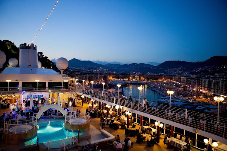 White Night begins with everyone dressed in white and waiting for the sun to go down so colorful lights can come up on board a Azamara cruise.