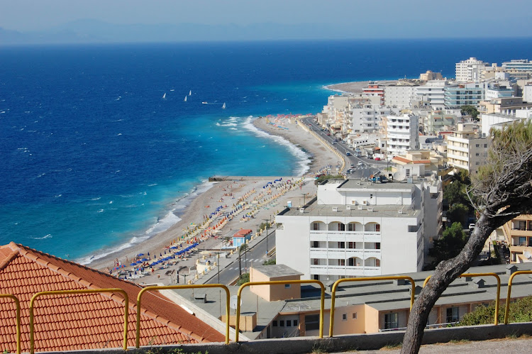 The beach along a well-developed commercial sector south of the city of Rhodes, Greece.