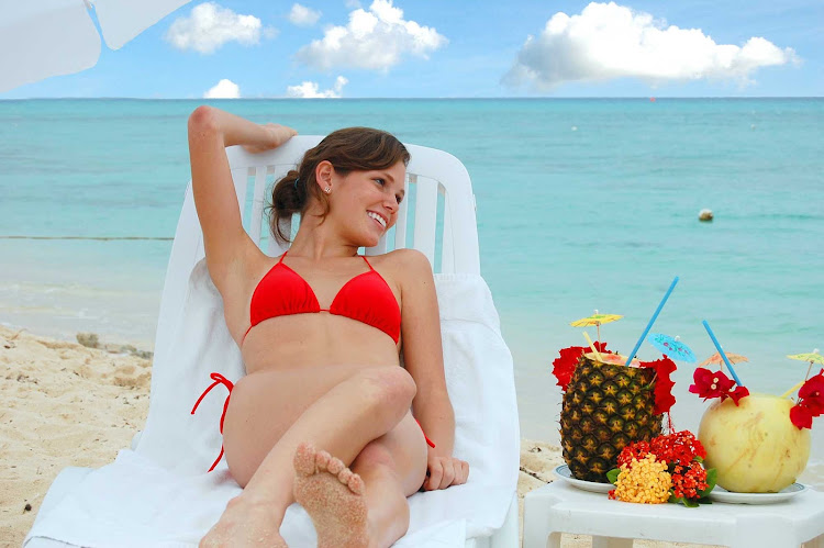 Catching some sun with colorful drinks is part of the Cozumel experience.