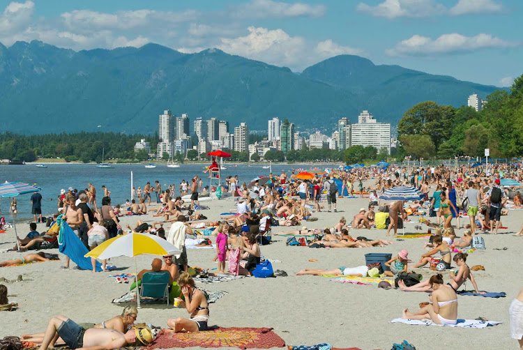 Kits Beach (formally, Kitsilano Beach)  with downtown Vancouver, BC, and mountains in the background