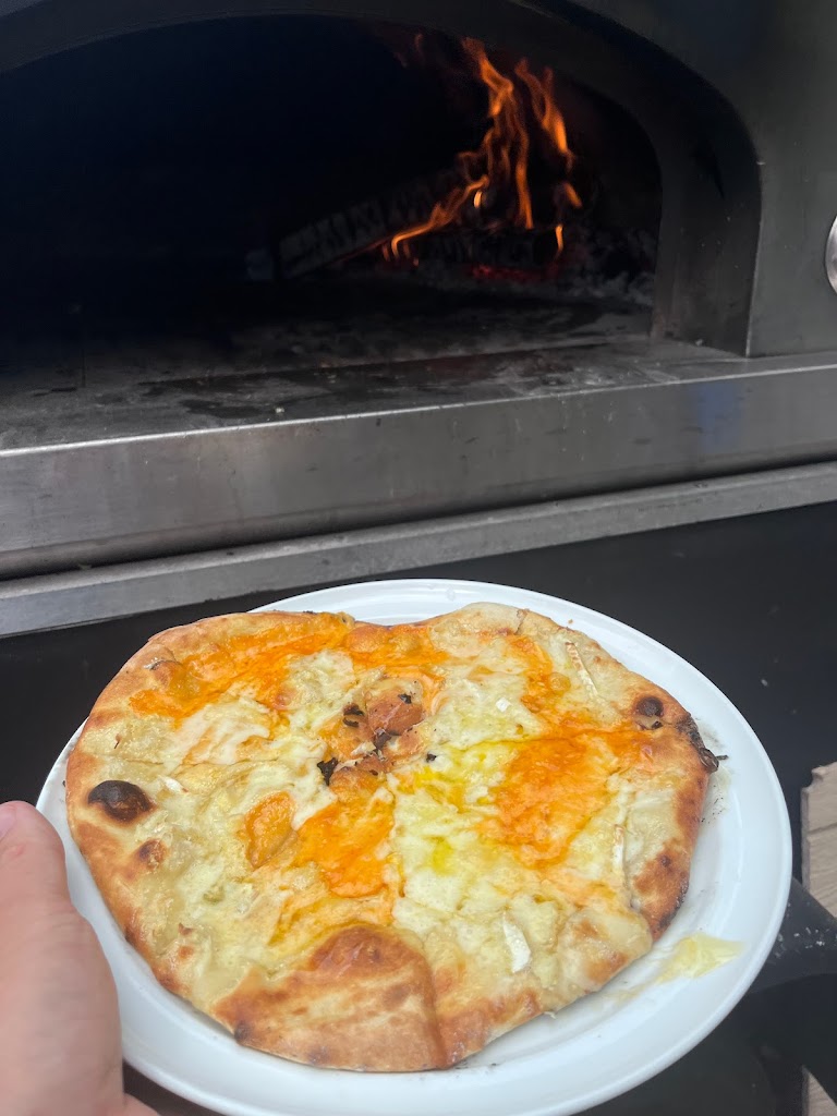 Slinging Dough Wood Oven Pizza