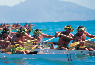 Tahitian outrigger races feature paddlers dressed in colorful pareos and traditional "heis" and leis for races and demonstrations.