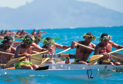 Tahitian outrigger races feature paddlers dressed in colorful pareos and traditional "heis" and leis for races and demonstrations.