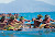 Tahitian outrigger races feature paddlers dressed in colorful pareos and traditional "heis" and leis for races and demonstrations.