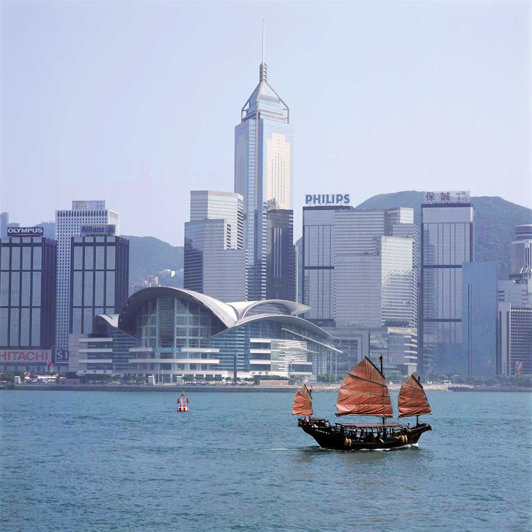 A junk sails in Victoria Bay, Hong Kong.