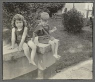 Klaas en Tiny Kleiterp zittend op een tuinmuur in Singkawang