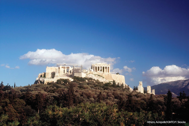 View of the iconic Acropolis set atop a hilltop in Athens, Greece. 
