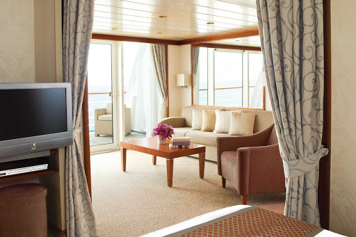 Enjoy a seating area opening up to your own private balcony when you choose a Horizon Suite aboard Seven Seas Mariner.