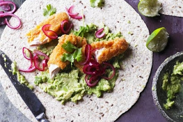 Smashed avocado with crispy chicken, pickled onions & tortillas
