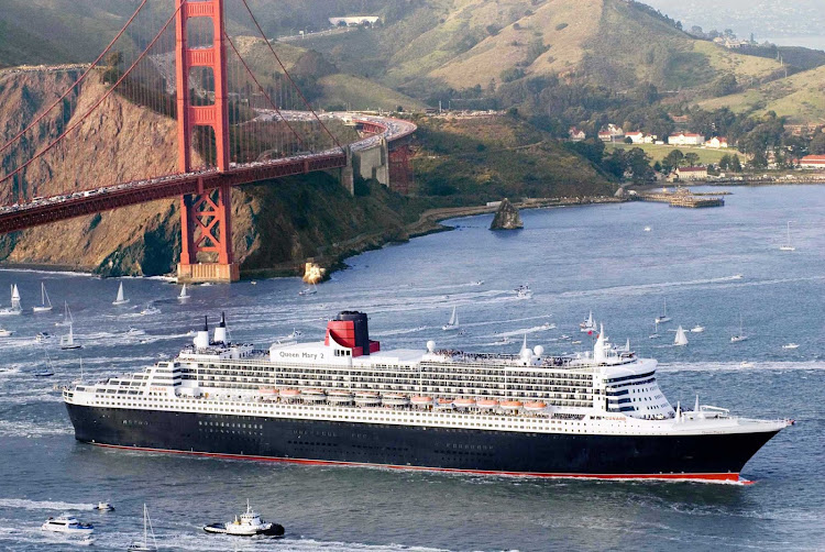 Queen Mary 2 enters San Francisco Bay as it passes below the Golden Gate Bridge.