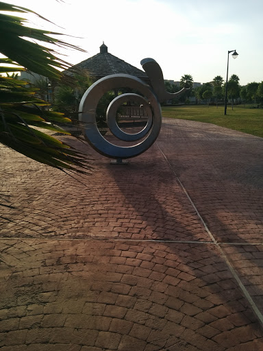 Shiny Swirl Sculpture In Island Park