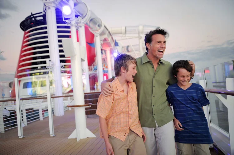 A father with his sons on the deck of Disney Dream. Disney ships have won a raft of "best for families" awards from Travel + Leisure, Conde Nast Traveler, Porthole Magazine readers and the Cruise Critic Cruisers' Choice Awards.