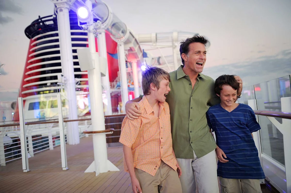 Disney-Dream-Father-Sons-on-Deck - A father with his sons on the deck of Disney Dream. Disney ships have won a raft of "best for families" awards from Travel + Leisure, Conde Nast Traveler, Porthole Magazine readers and the Cruise Critic Cruisers' Choice Awards.