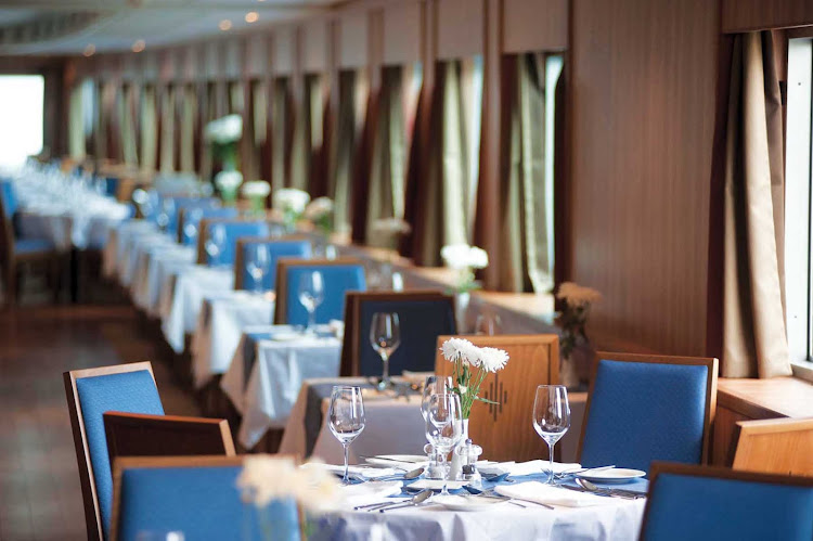 Experience intimate dining with scenic views and good company in the restaurant aboard your Viking River Cruises ship during your exploration of Russia.
