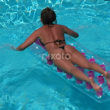 swimming pool floating girl by Rob K -  