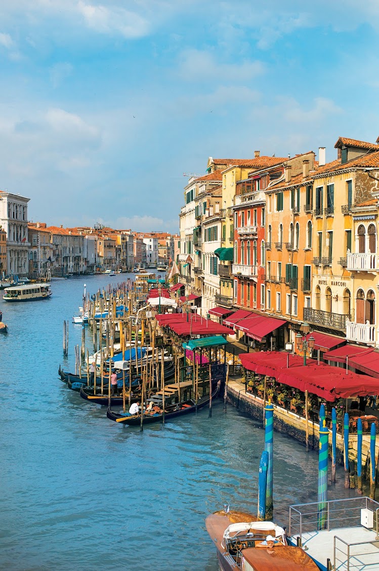 Cafés, hotels and homes along the Grand Canal of Venice, one of the memorable stops aboard a Tere Moana cruise.