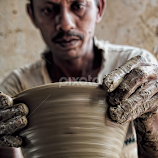 Clay pot maker at work by Nish Veer -  